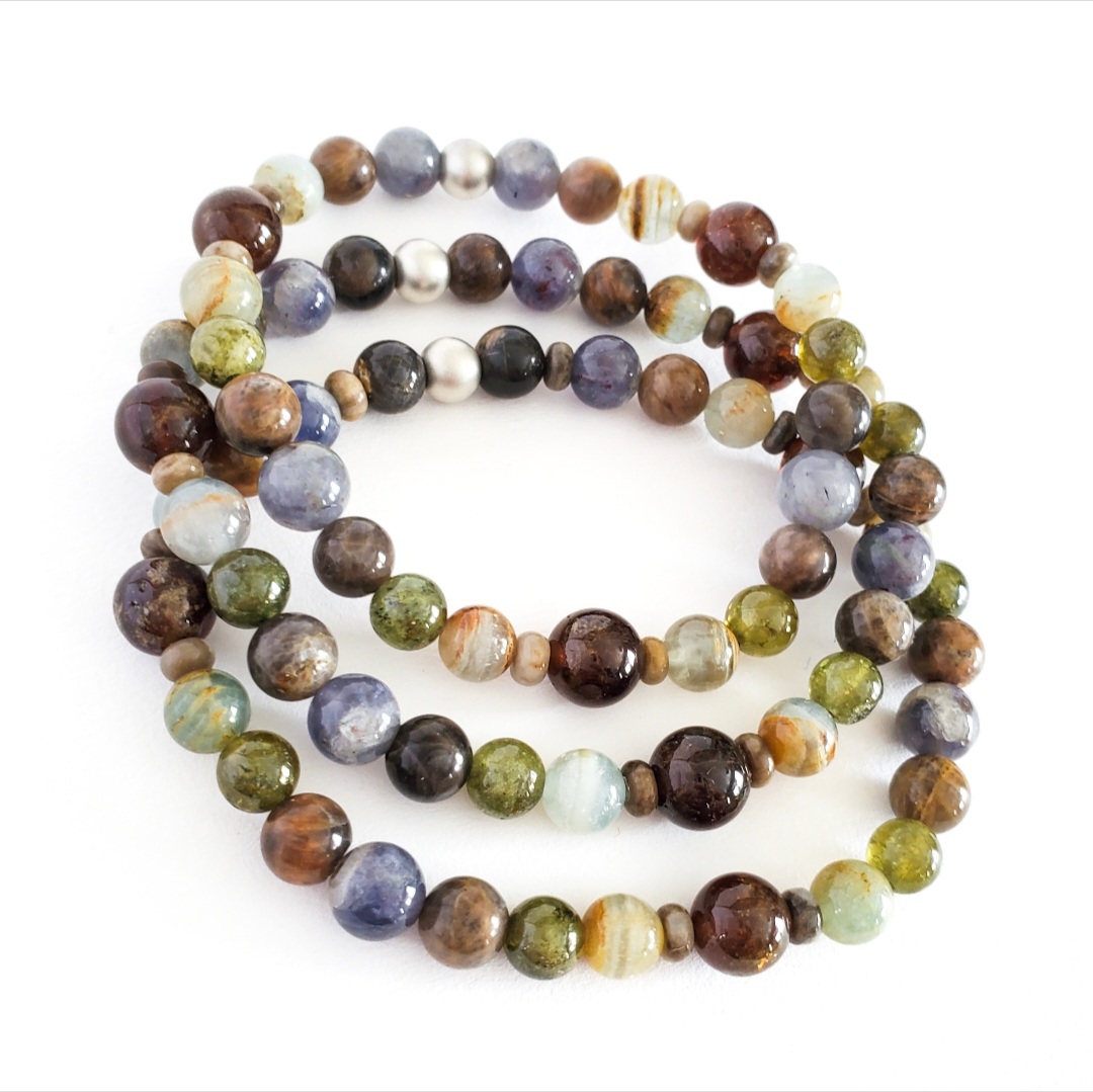 Three beaded gemstone bracelets in earth-tone stones with silver accent beads